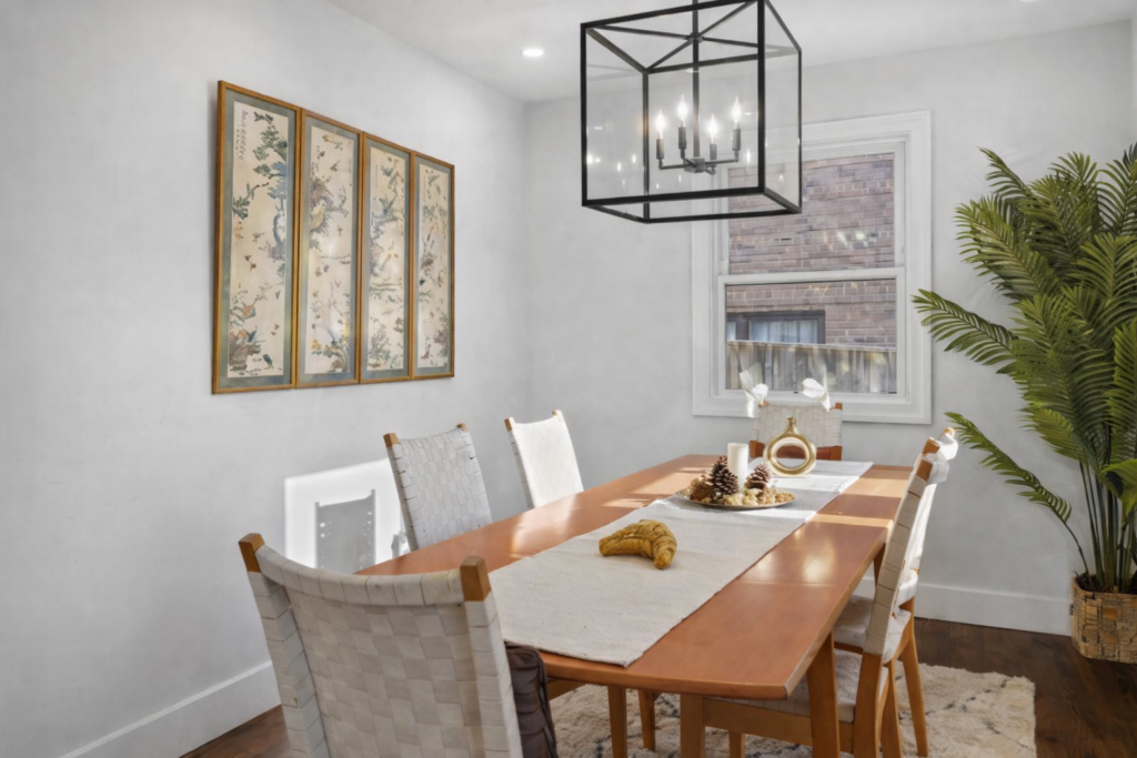 Asian-inspired home staging with celadon vase, neutral sofa, and subtle accent decor in a bright living room