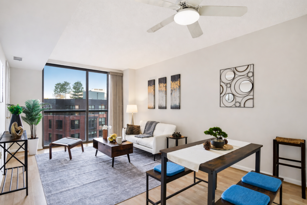 Home staging Washington DC apartment living room with natural light, modern furniture, balcony view, and neutral decor