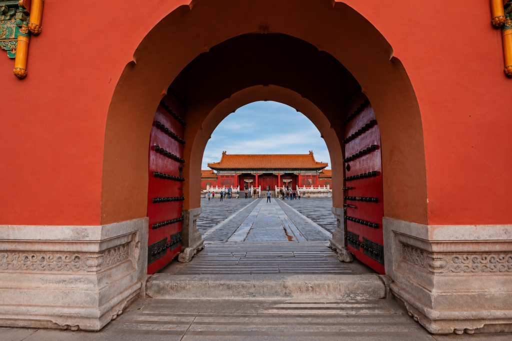 Traditional red archway inside the Forbidden City in Beijing China with symmetrical architectural design