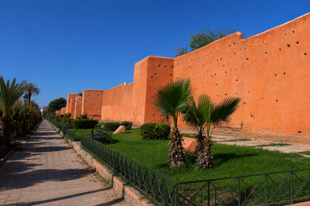 Coral red exterior wall in Marrakech Morocco showing bold color used across full architectural surfaces