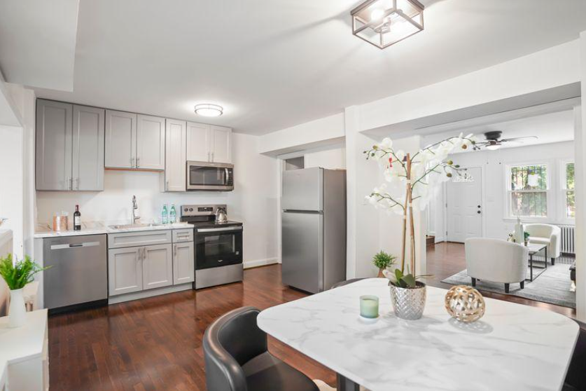 Staged Kitchen and Dining Room Washington DC Harvard Home Services Professionally staged kitchen and open concept dining area in Washington DC with marble table and orchid