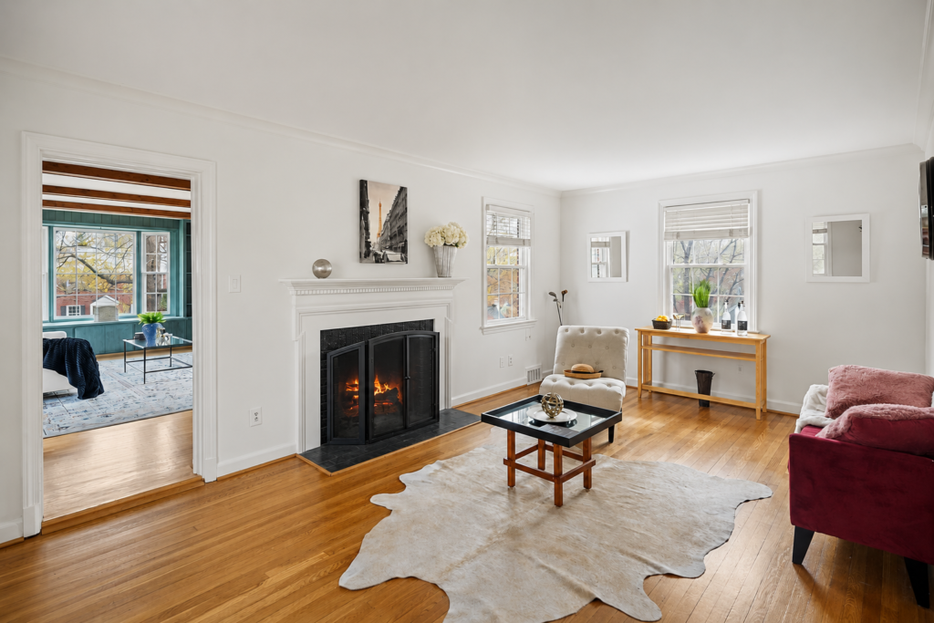 Home staging living room by Harvard Home Services in Washington DC with fireplace, hardwood floors, and natural light