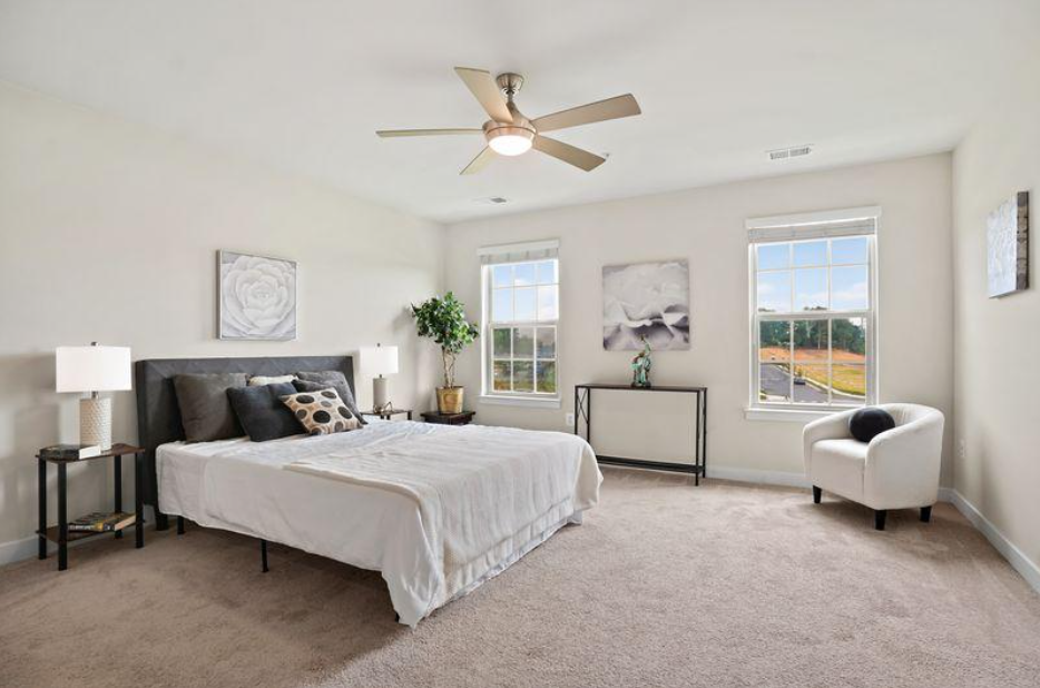 Staged primary bedroom after professional home staging at 5722 Richmanor Terrace Upper Marlboro Maryland by Harvard Home Services