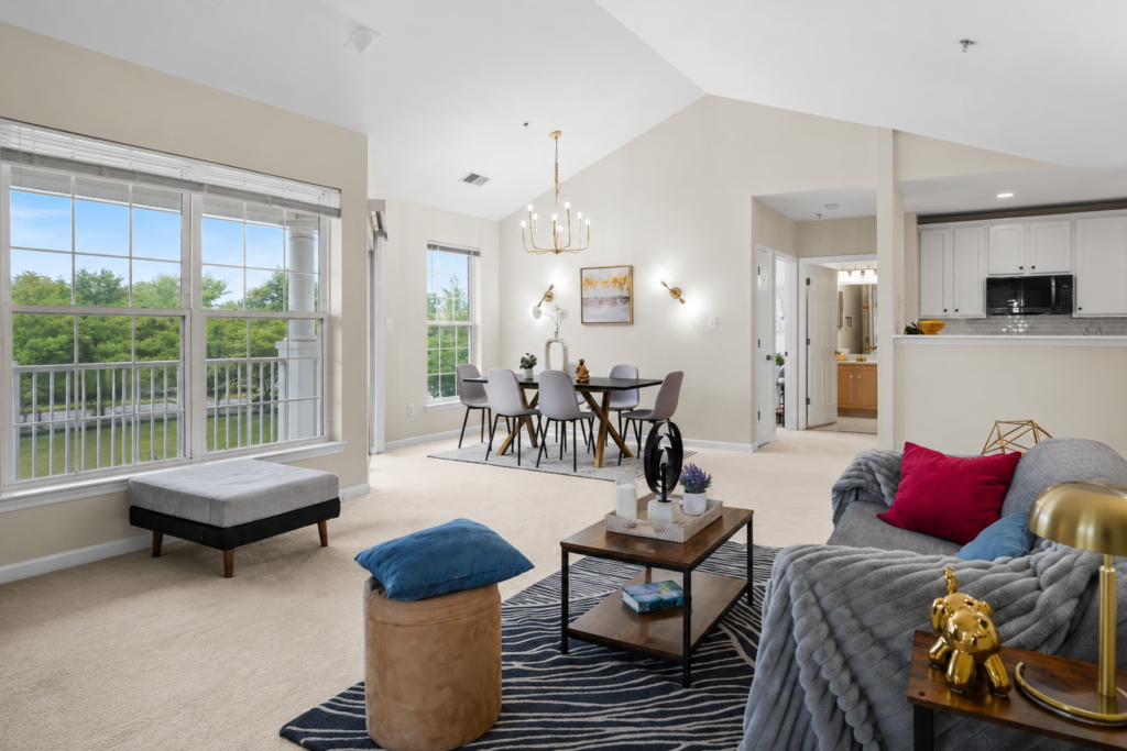 Professionally staged open concept living and dining room with vaulted ceilings at 25340 Lake Mist Chantilly Virginia by Harvard Home Services